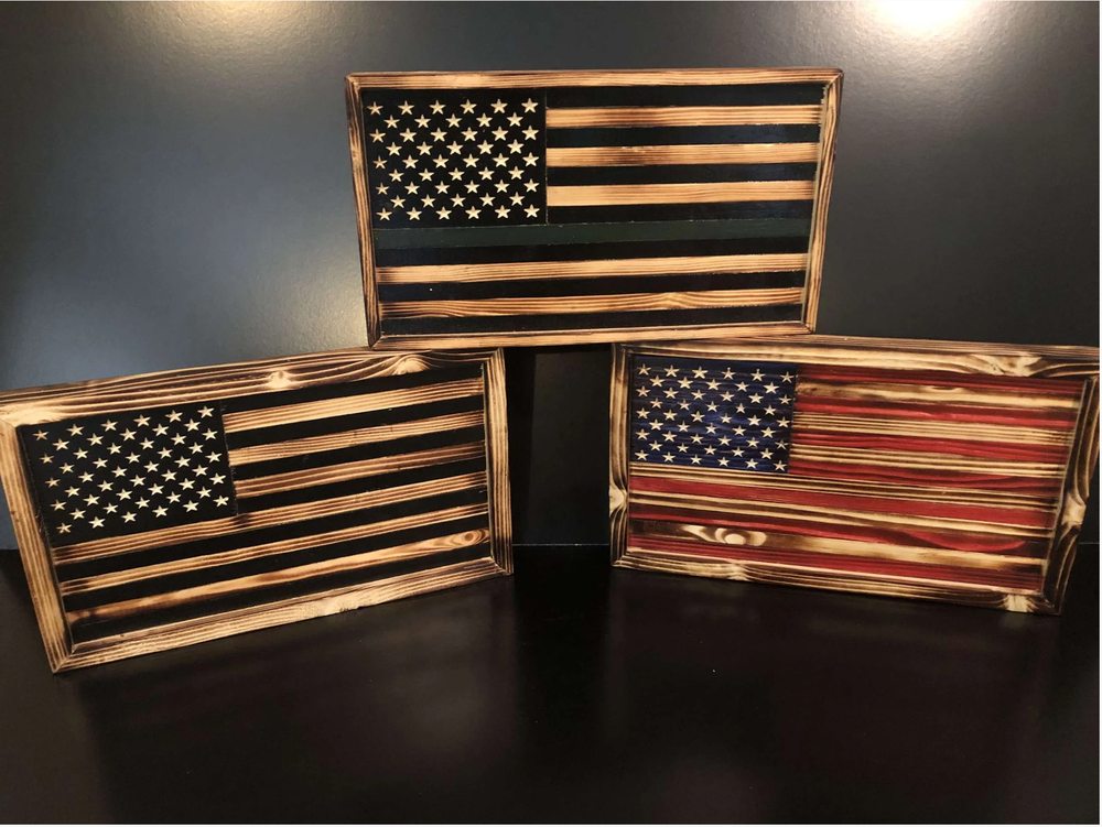 Three hand-finished wooden American flags arranged together, including a thin-line tribute flag